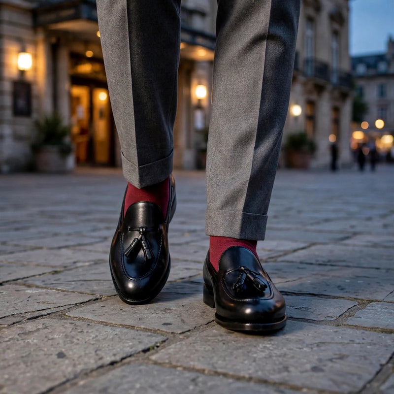 Black box calf tassel loafers worn with a grey double-breasted suit